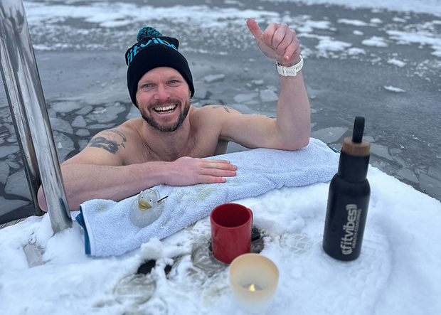 Halbporträt von Trainer Jan Kruse aus Glücksburg beim Winterbaden am vereisten Steg in der Ostsee freudig lachend 